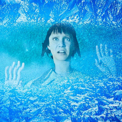 Woman falls into icy lake and her astonished face is capture